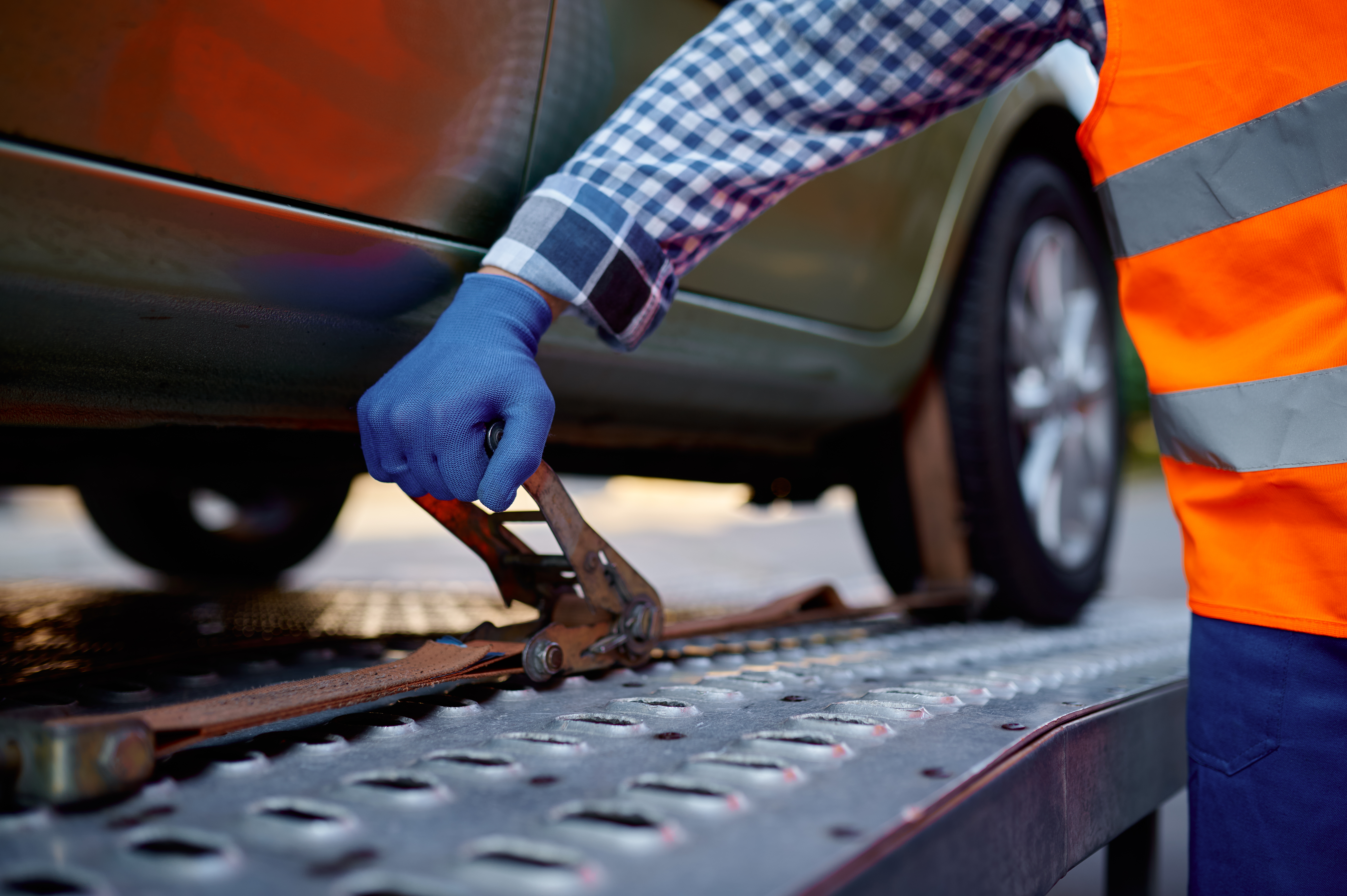 Closeup tow truck driver hand fixing car